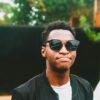 man in black sunglasses and white crew neck shirt