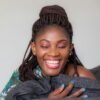 smiling woman holding gray apparel