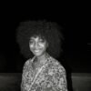 a black and white photo of a woman with an afro
